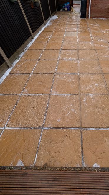 Newly laid patio tiles with fresh grout.