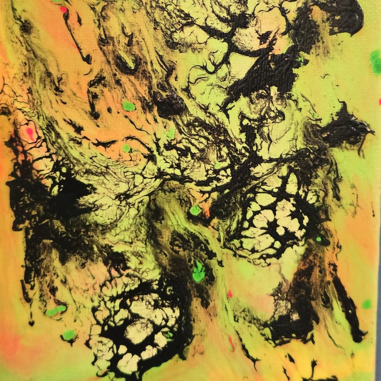 Close-up of textured yellow and black abstract pattern with hints of green.