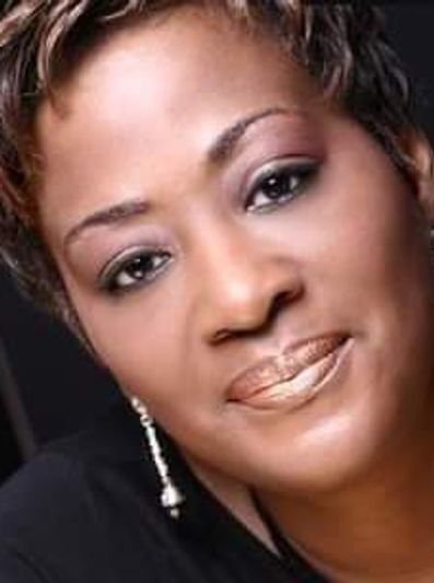 Close-up portrait of a woman with elegant makeup and earrings.