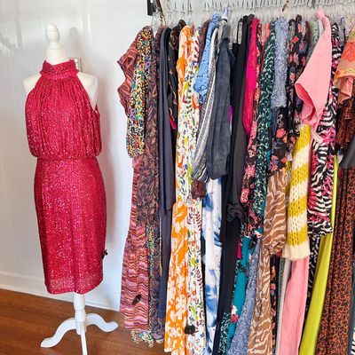 image showing a mannequin in a bright pink sequins dress next to Celery's long dresses clothing rack