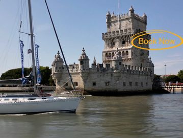 A sailing boat in front of Belem Tower