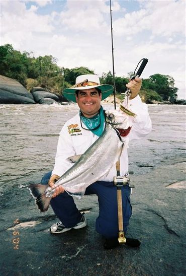 Man smiling and holding a fish