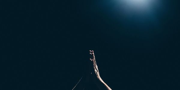 Prayer hands on a dark background