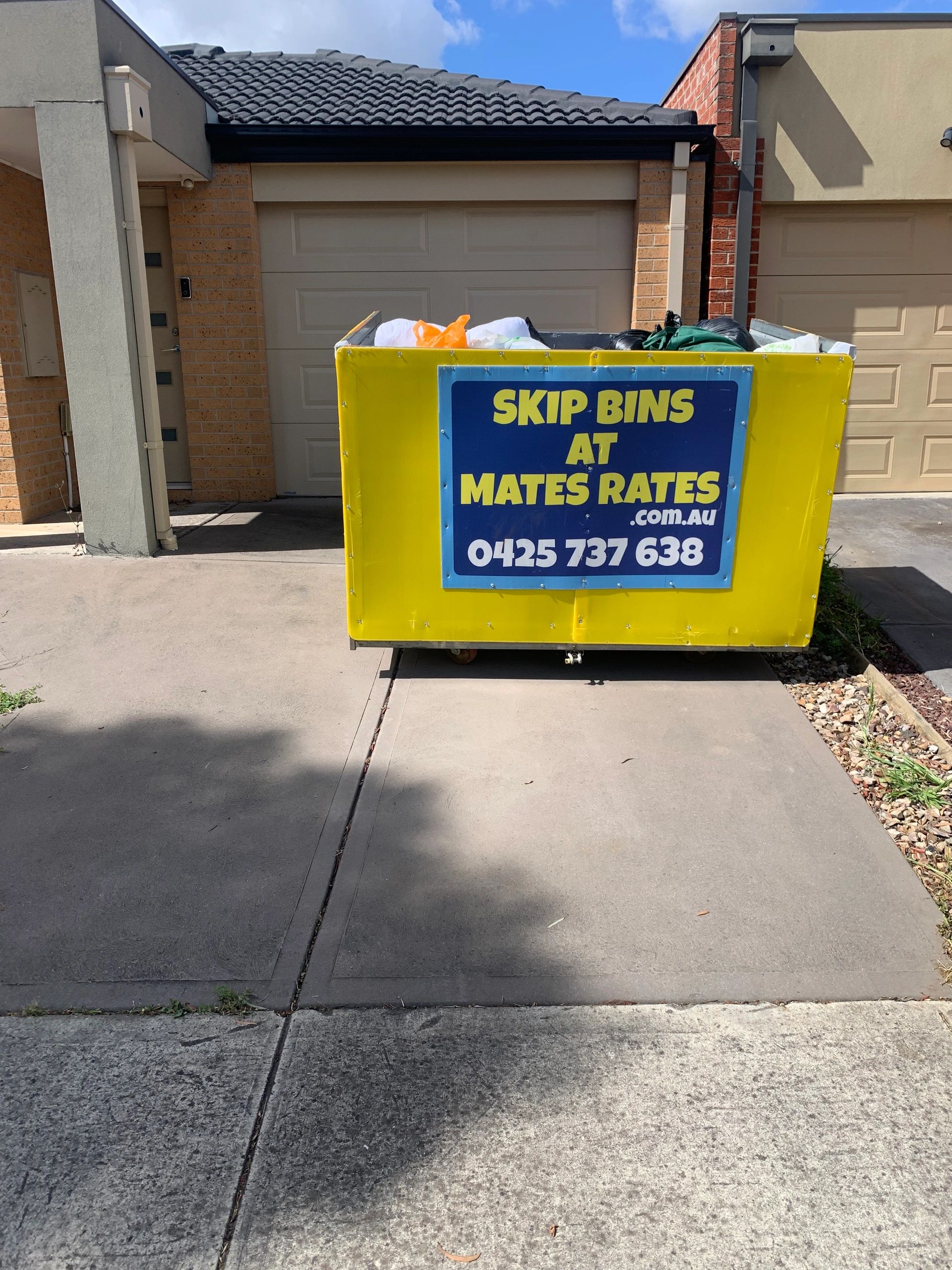 Skip bin hire. Rubbish removal. Skip bin in driveway.