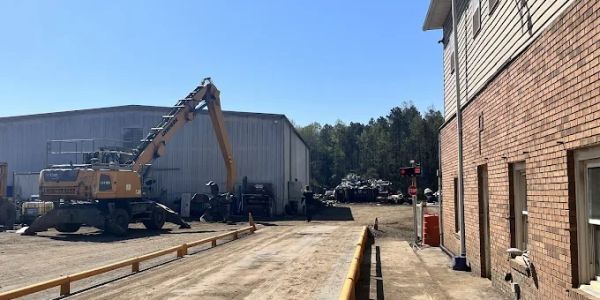 Industrial yard with machinery and equipment on a sunny day.