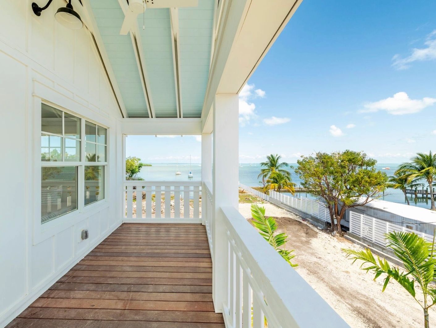 the porch of an Islamorada home is pictured with the ocean in the distance.