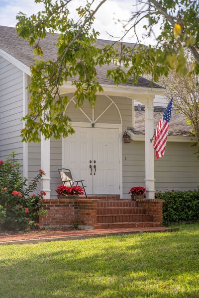 Front door with an American flag in a Homeowners Association Managed by Harbor Management Services