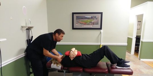Dr. Scot adjusting his patient's neck
