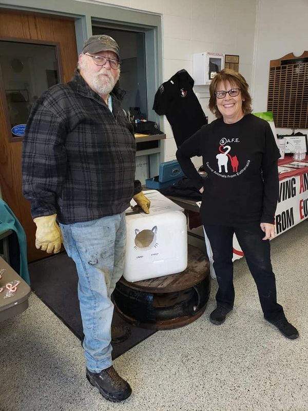 Peggy Butler with, volunteer, Dean Martin show off our upcycled feral cat houses. 