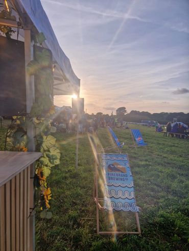scenic photo with the setting sun peering over the corner of the bar