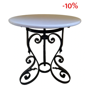 Mesa redonda con base de hierro forjado negro y superficie blanca.