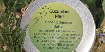 A tin of Cucumber Mint Cooling Summer Butter with ingredient label.