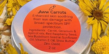 A close-up of a skincare product label named Aww Carrots with natural ingredients and SPF protection.