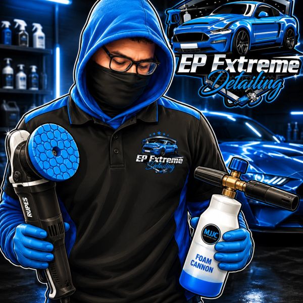 Man in blue hoodie holding car detailing tools in a garage.