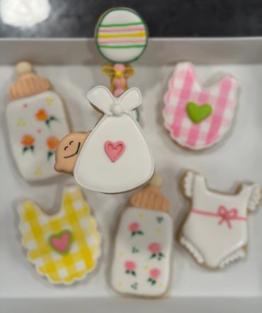 Decorative baby-themed cookies in pastel colors.