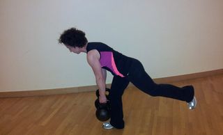 My persoanal training client performing a 1 leg deadlift with two 20kg kettlebells