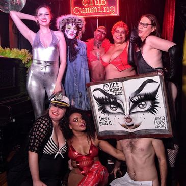 Group in creative costumes posing at Club Cumming.