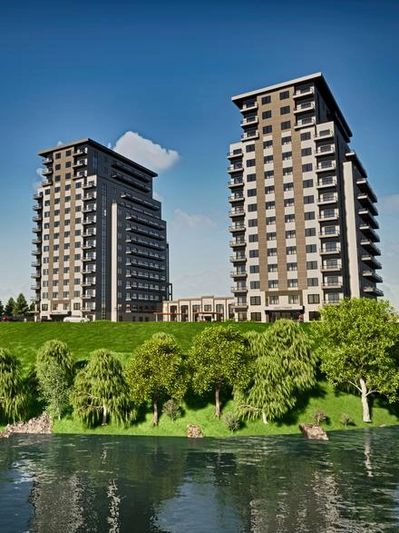 A rendering of two modern residential buildings overlooking a body of water and green landscape.