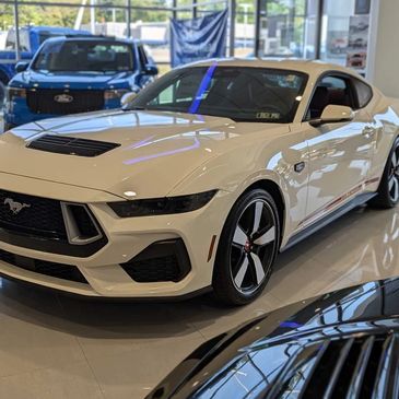 White Ford Mustang parked indoors.
