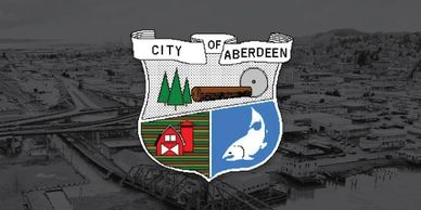 City of Aberdeen Logo, shown over an aerial photo of Aberdeen and the Chehalis River. 