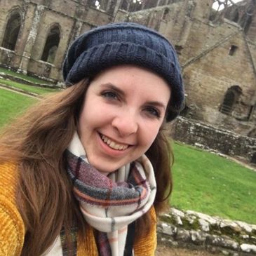 English teacher in front of building in England