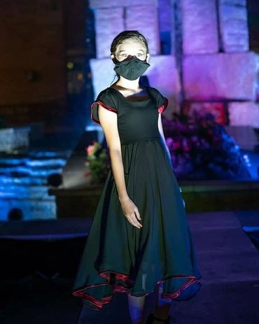 Young girl posing with her dress at the fashion show