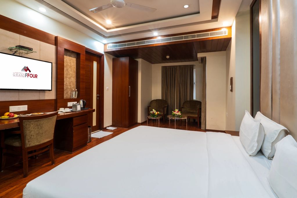 Deluxe Room at Hotel Grand FFOUR New Delhi spacious interiors with king bed and elegant furnishings