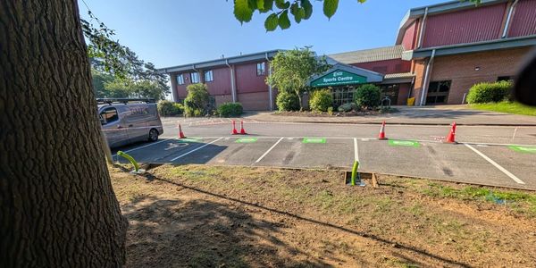 Parking lot outside a sports center on a sunny day.