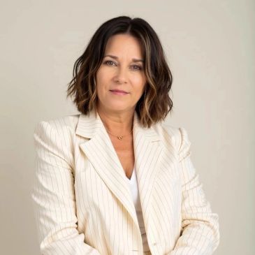 Confident woman in a cream blazer.