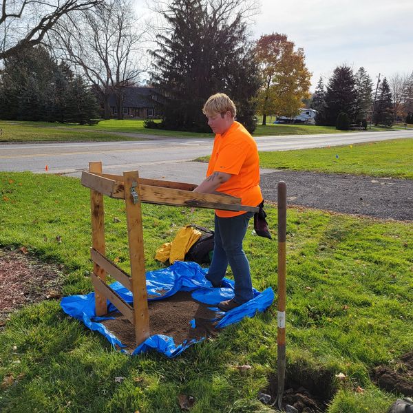 An Archaeologist sifting for cultural materials.