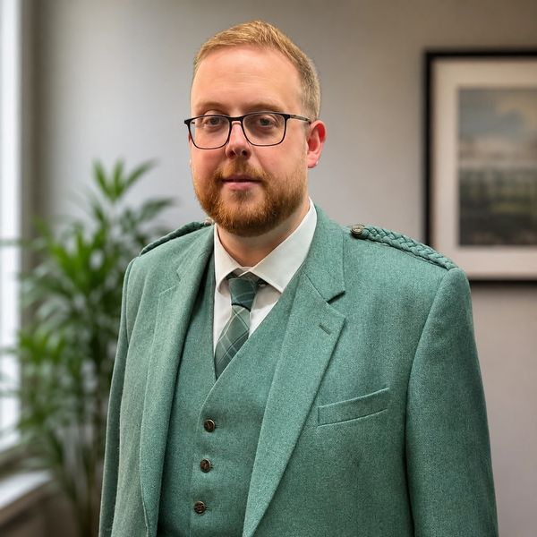Man in green suit with glasses.