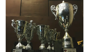 A collection of shiny silver trophies on display.
