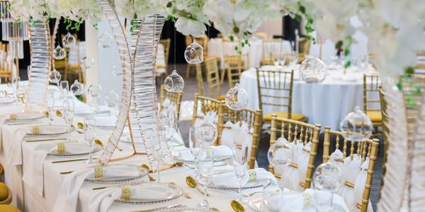 Elegant wedding reception setup with white and gold decor.