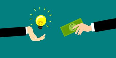 Exchanging money for a bright idea symbolized by a light bulb.