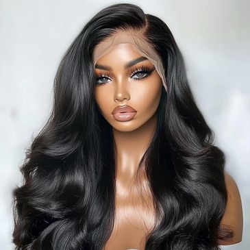 Woman with long wavy black hair and striking makeup.