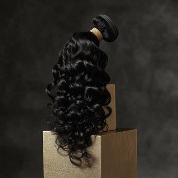 Long black wavy hair bundle displayed on a golden pedestal.