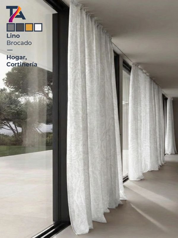 White linen brocade curtains hanging along large glass windows.