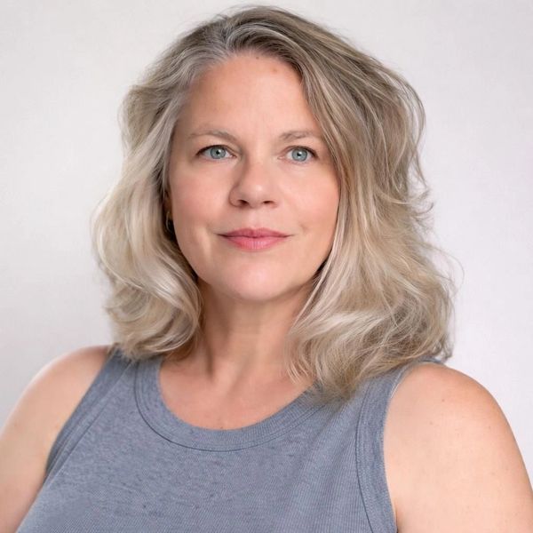Confident middle-aged woman with shoulder-length blonde hair.