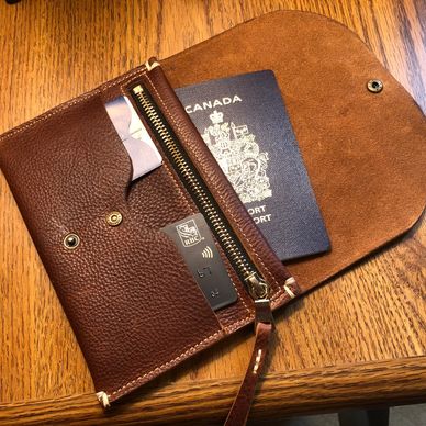 Brown leather wallet with Canadian passport and RBC credit card inside.