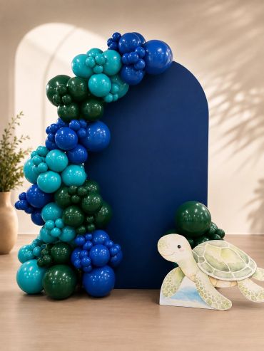 Blue and green balloon arch with turtle decoration.