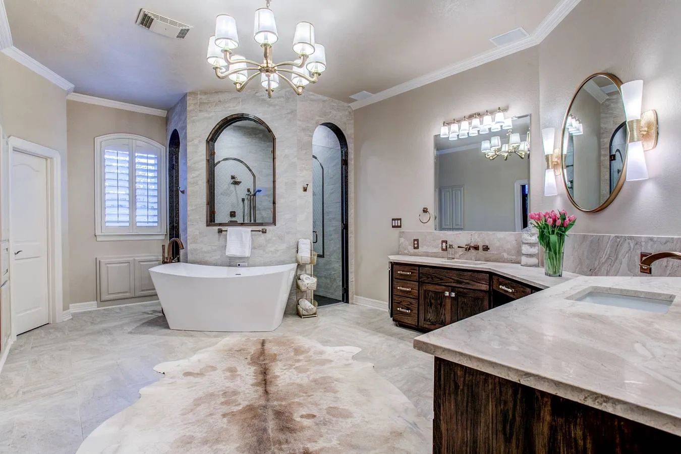 Luxurious bathroom with freestanding tub and elegant chandelier.