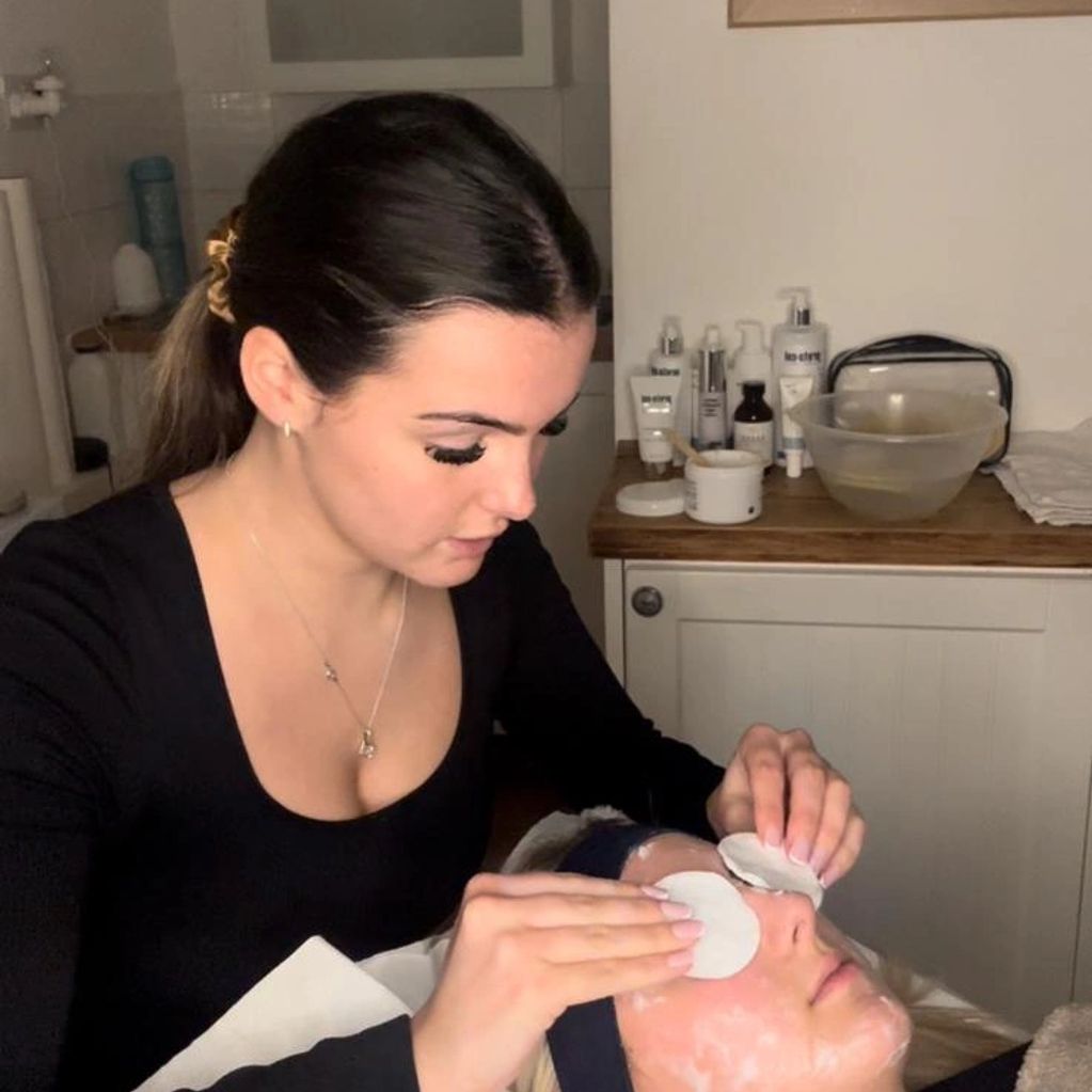 Therapist doing a facial on a client