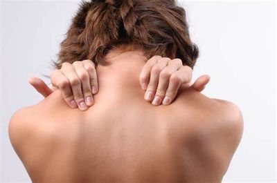 a person massaging their own shoulder muscles