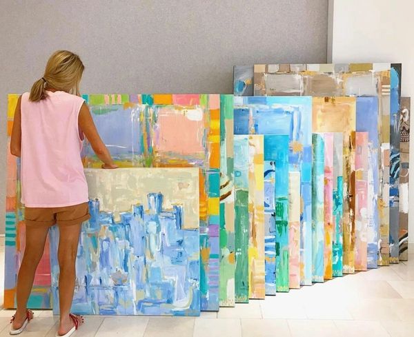 Artist with colorful abstract paintings
