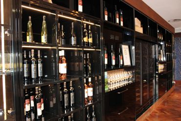 Elegant wine display with bottles and glasses in a sophisticated setting.