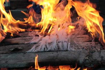 Wood logs burning with bright orange flames.