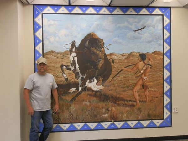 Jim with an 8'x9' mural he painted at Montana State University in the Indian Club room.