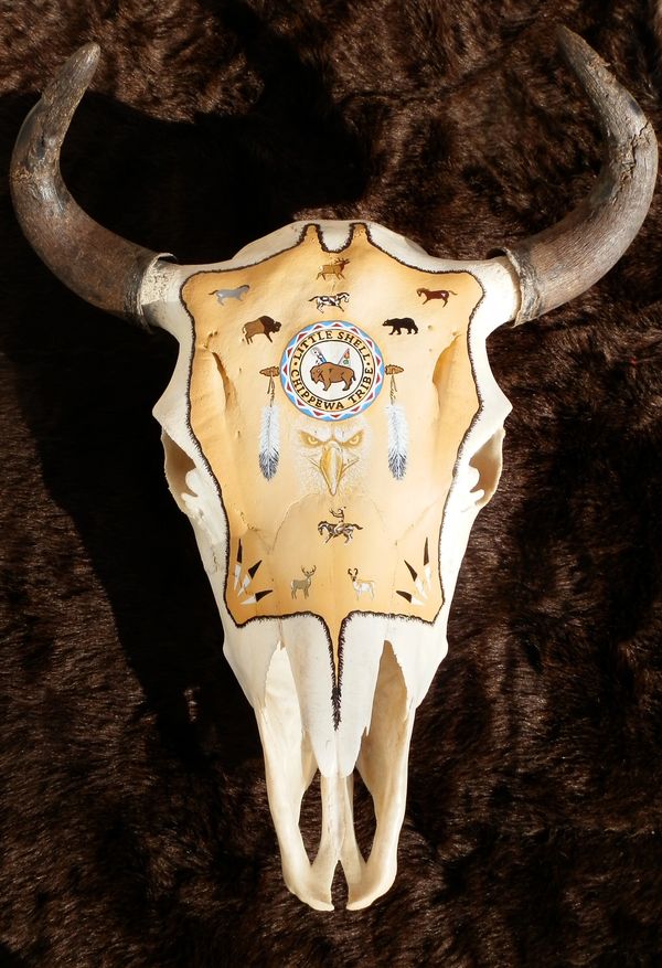 Buffalo skull with images that tell the story of Jim's life.