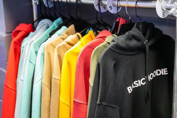 Different hoodies hung inside a cabinet