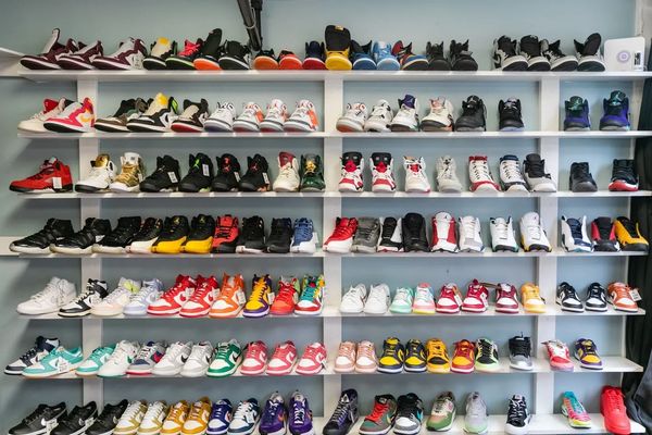 Different pairs of shoes displayed on a cabinet